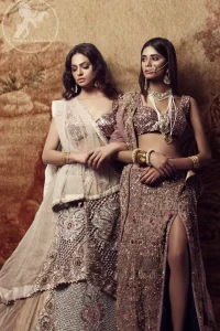 Brighten up your look with this outfit. The blouse is made of shimmer fabric to give its a regel look. It comes with full heavily embroidered lehenga with zardosi work details and rich hemline. This double layed lehenga is also enhanced with intricate embroidered net and multiple color embroidery. It is coordinated with tissue dupatta which is sprinkled with sequins all over it and pearls on the four sides of border.