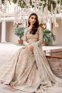 This outfit is adorned with kora, dabka, tilla, sequins and pearls. It is decorated with floral embellishments. It is overlapping shirt which adds to the look. It comes with heavy embellished lehengha allured with geometrical pattern all over it which has thick border on hemline. Tissue dupatta accompanies the garment. The dupatta has embellished borders on all four sides and small floral motifs all over it. The garment is lined with medium silk.