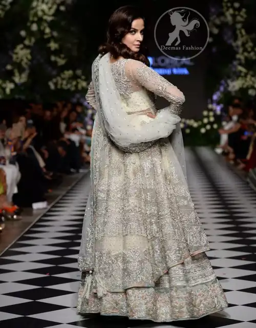 Feel glamorous in our ivory back trail frock with fascinating embellishment on neckline with silver kora, dabka, pearl and sequins.