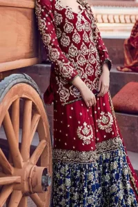 A beautiful short shirt heavily embellished with silver work enhanced with kora, dabka, tilla, sequins and stones. It is artistically coordinated with blue jamawar farshi gharara with floral embellished pattern at the bottom and finished with an appliqued embellished border. It is beautifully coordinated with jamawar dupatta sprinkled with small motifs andan appliqued border finished around dupatta.