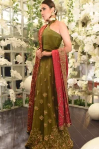 This dress is beautifully decorated with heavy embroidery. It is highlighted with dull golden kora, dabka, tilla, sequins and pearls. Fish lehengha is fully embellished.Blouse is scalloped. It comes with beautifull upper gown, sprinkled with sequins all over it. It is coordinated with chiffon dupatta which is sprinkled with sequins all over it.