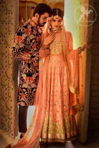 A handful of stardust on a contemporary dress, crafted delicately with dainty floral embroidery and gotta work embroidery. It is beautifully captivated with golden kora dabka, pearl and kundan work. It is finished with heavy embroidered and lace on border. Paired up with churidar pajama and net dupatta with sprinkled sequins and piping on all sides.