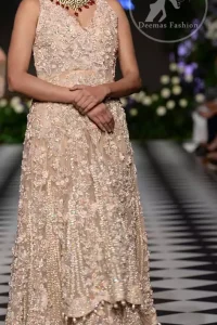 Brighten up your look with this outfit. This dress is beautifully sculptured with floral embroidery, adorned with cutwork borders embellished with dull golden kora, dabka, pearl and sequins work all over. Sharara comprises of floral thread embroidery and zardosi work adorned with thick embellished border. It is coordinated with tissue dupatta which is sprinkled with sequins all over it. It is further furnished with four sided scalloped border.