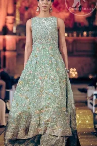 Reflecting exuberant color play in this ethereal piece meticulously highlighted with zardosi work. Heavily embellished in the front with intricate embroidered pattern done with silver and golden kora, dabka, kundan, tilla and sequins. It comes with fully embellished lehenga. Frock and lehenga both are decorated with applique on the bottom. The outfit is coordinated with net dupatta which is sprinkled with sprinkled sequins. It is further furnished with four sided scalloped border.