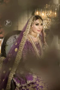 Reflecting royalty and the majestic beauty of statuesque shape and silhouette this bridal dress is perfect for your special day. This dress is beautifully decorated with heavy embroidery. It is highlighted with golden kora, dabka, tilla, sequins and pearls. The short shirt is decorated from neckline and scalloped hemline is decorated with zardosi work. Lehenga is enhanced with floral patterns all over with golden embellishment.  It is coordinated with chiffon dupatta which is sprinkled with small floral motifs all over.