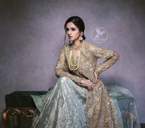 artistically embellished to give a beautiful rhythm to the outfit. The gown is heavily embellished with antique zardosi work and