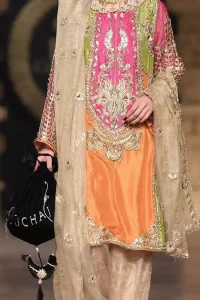 This dress is perfect for party wear due to its uniqueness and the perfect fusion of modern cut and traditional embroidery. It is beautifully decorated with heavy embroidery and the shirt is enhanced with embellished applique of two different colors. It is highlighted with kora, dabka, tilla, sequins and pearls. It comes with self printed shalwar which is enhanced with laces on bottom. It is coordinated with tissue dupatta which is sprinkled with small floral motifs all over it. It is further allured with laces all around the edges.