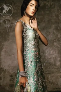 Delicately crafted and personifying chic elegance with an element of grandiose. Heavily embellished in the front with intricate embroidered pattern done with golden and silver kora, dabka, kundan, tilla and sequins. It is further decorated with scalloped boder which having tassels to complete the look. The back of the shirt is embellished with different types of motifs. It comes with matching sharara sprinkled small motifs all over. It is coordinated with olive green chiffon dupatta which is sprinkled with sequins all over it.