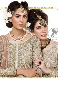 The perfect combination of tradition and class. Dazzle in this made to perfection, richly embroidered front open net outfit decorated with intricate zardozi embroidered front highlighted with kora, dabka, tilla, sequins and pearls embroidered borders on daaman and sleeves. Furthermore the shirt is fully decorated with sprinkled pearls all over it. This outfit is comprises with light olive green sharara highlighted with zardozi details at the bottom. Complete the look with tea rose dupatta sprinkled with sequins all over.