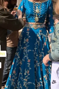 Feel glamorous in our venice blue blouse skirt with fascinating embellishment on neckline with silver kora dabka, pearl and sequins. The bridal stands out due to its uniqueness and the perfect fusion of modern cut and traditional embroidery. Blouse has simply sprinkled with perals and lehenga has embroidered applique on bottom and embellished waist belt. It is coordinated with tissue dupatta which is sprinkled with sequins all over it. It is further furnished with four sided embellished border.