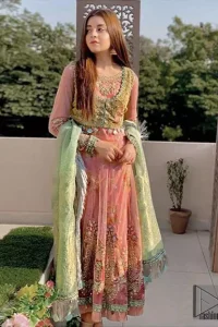 This pishwas is the perfect combination of tradition and class for mehndi mayon function or nikah day. Wear this soft and supple hues richly decorated by shades of golden and whites with thread embroidered motifs and floral bunches at daaman. The bottom of the pishwas is enhanced with lace finishing and tassels. Style it up with fully embellished velvet jacket. It comprises with churidar pajama. This nikah dress is coordinated with brocade dupatta having lace border on all four sides.