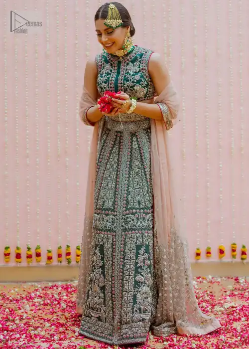 Bottle Green Velvet Blouse Lehenga Tan Dupatta. Blouse is beautifully decorated with multiple color floral embroidery.