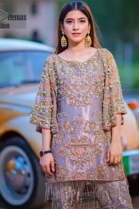 Tradition meets modernity. This outfit is stunningly perfect for any evening ensemble. This dress is beautifully sculptured with floral embroidery, adorned with bell sleeves embellished with antique shaded kora, dabka, pearl, sequins and multiple color resham embroidery all over. The bottom of the shirt is enhanced with rich zardosi embroidery and finishing with tassels at the end. It comprises with fully embellished gharara. Pair it up with matching dupatta ornamented with scattered tiny floral motifs and sequins.