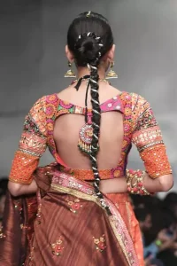 This dress is majestic beauty and perfect for mehndi mayon day. Delicately crafted and personifying chic elegance with an element of grandiose. A full heavily embellished blouse with multiple color resham thread embroidery and mirror work details. Having half sleeves adorned with mirror work. It comprises with self printed lehenga finishing with dull golden lace at the end. Style it confidently with chocolate brown dupatta with thick embellished border on the front and comparatively lighter work border on long edges. Medium and tiny sized ornamental motifs scattered all-over.