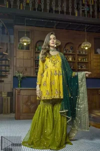 This dress is perfect for mehndi day. Delicately crafted and personifying chic elegance with an element of grandiose. This mehendi and mayun dress is beautifully sculptured with floral embroidery on neckline adorned with scattered embellished with dull golden kora, dabka, pearl and sequins work all over. Having full length sleeves adorned with motifs. It comprises with mehndi green gharara sprinkled with sequins to convey a classic style. Beautifully coordinated with bottle green dupatta with thick lace border.