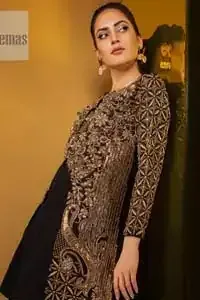 Perfected with antique gold and dark antique embellishments this black velvet ensemble is timeless masterpiece in to a chic fantasy. Delicately crafted with zardosi, kora, dabka, tilla, sequins and pearls. Furthermore it is adorned with geometric patterns all over.  Beautifully designed sleeves is an amalgamation of geometric and floral design elements. This outfit is finished with black raw silk palazzo pants and pure chiffon dupatta.
