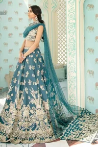 Captured in traditional silhouette. The bridal stands out due to its uniqueness and the perfect fusion of modern cut and traditional embroidery. It is highlighted with light golden kora, dabka, tilla, sequins and pearls. Blouse is enhanced with zardosi work. It comes with full embellished lehenga adorned with different size motifs and floral bunches. Style it up with net dupatta which is sprinkled with sequins all over it and embellished pallu to give it a perfect look.