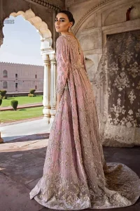 Exude elegance and class in this back trail maxi finessed with beautiful embellishment. The outfit is beautifully sculptured with floral embroidery, adorned with vertical lines and fixed waist belt embellished with silver and light golden kora, dabka, tilla and sequins work all over. The back of the outfit has an artistically designed motif. The outfit is styled with a hand embellished crystal belt. It comprises with cigarette pants and light pink net dupatta ornamented with sprinkled sequins on the ground and four sided light border.