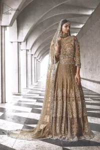 An example of beauty and elegance. Our bride makes a statement in this stunningly floraison, perfect blend of glamour and tradition with outstanding craftsmanship and gorgeous detailing. The cold shoulder blouse is stunningly embellished with intricate embroidered neckline done with light golden and silver zardosi work all over. Lehnga is compiled with zardozi embellishment which gives this festive season a flattering dimension to die for. The outfit is coordinated with beige net dupatta adorned with scattered sequins all over and four sided border.