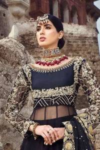 Delicately crafted and personifying chic elegance with an element of grandiose. This regal black outfit is an immensely captivating traditional piece, enhancing the art of classical heritage showcasing the craftsmanship of golden kora, dabka, tilla detailed with sequins and pearls; artistically embellished to give a beautiful rhythm to the outfit. Furthermore the anarkali frock is enhanced with fascinating embellishment on neckline and frilled hemline. It comes with an exquisite black lehenga with thick embroidered bottom to give it a regal look. It comes with a black net dupatta with sequins sprayed all over finished with thick embellishment all around the edges.
