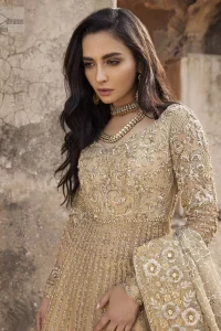 Captured in traditional silhouette, The bridal stands out due to its uniqueness and the perfect fusion of modern cut and traditional embroidery. It is highlighted with kora, dabka, tilla, sequins and pearls. Pishwas is enhanced with zardosi work on bodice, vertical lines and the daaman is emphasized with intricate zardosi details that gives perfect ending to this outfit. A handcrafted pale gold lehenga finished with thick embellished borders completes the look. The outfit is coordinated with chiffon dupatta with hand embroidered borders on all four sides and geometric patterns on the ground.