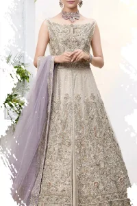 The ultimate in feminine elegance with fine detail to die for. Our bride makes a statement in this stunningly floraison, perfect blend of glamour and tradition with outstanding craftsmanship and gorgeous detailing. This front open pishwas is gorgeously decorated with floral bunches all over done with antique shaded zardozi work. It comprises with light beige jamawar lehenga with zardozi detail on the bottom. Style it up with light purple net dupatta sprinkled with sequins and four sided embellished border.