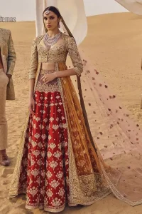 This weeding outfit makes a statement in this stunningly floraison, perfect blend of glamour and tradition with outstanding craftsmanship and gorgeous detailing. Heavily embellished blouse and bottom done with golden zardozi work and detailed central slits instantly draws attention. The lehnga with embroidered motifs spread all over and thick embellishment on lower waist. Paired it up with light pink net dupatta sprinkled with tiny motifs and four sided border.