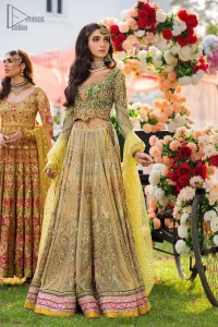 A perfectly pretty combination for a mehndi function. Gussy up the glamour with this intricate embroidered blouse accentuated with golden kora, dabka and tilla work and scalp finishing. The lehenga is emphasized with traditional style done with zardozi work in the shade of golden. Furthermore it is adorned with multiple color applique bottom which complete the look. It is coordinated with yellow dupatta sprinkled with sequins on the ground and scallop border. 