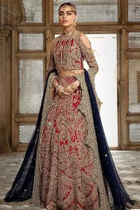 A breathtaking red traditional lehenga  paired with a detailed blouse, equally alluring make for an ensemble which is comfortably chic. The blouse is done with golden and antique shaded embroidery and finishing with tassels. Blouse having cold shoulder full sleeves. The lehenga is enhancing with the art of classical heritage showcasing the craftsmanship of kora, dabka, tilla, kundan and sequins detailed, artistically embellished to give a beautiful rhythm to the outfit. It comprises with navy blue dupatta sprinkled with sequins and four sided scalloped border. This is an ensemble that is sure to invite compliments galore.