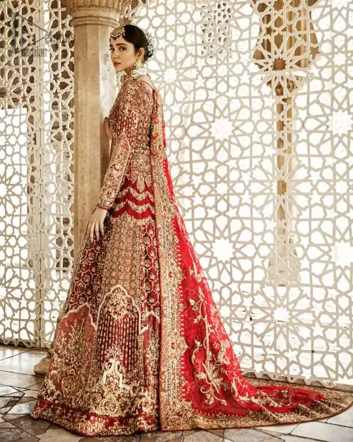 Captured in traditional silhouette, This traditional red pishwas is aesthetically designed with motifs,geometric and floral patterns, embellished with kora, dabka,