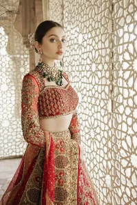 Classic, timeless and truly beautiful, our bridal dress is perfect for your unforgettable day. This exceptionally detailed dress is cut in a seductive fit and flare silhouette that’s sure to turn heads. The blouse is adorned with antique shaded kora, dabka, tilla, kundan, sequins and pearls. Coordinated with traditional red lehenga having geometric patterns and floral embroidery ornamented with antique shaded zardozi work. The hemline is also adorned with vibrant floral motifs. Elegance is personified when it gets paired up with red organza dupatta having four sided thick embellished border.