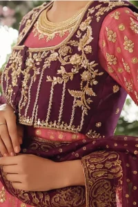 This exceptionally detailed dress is cut in a seductive fit and flare silhouette that’s sure to turn heads. Discover classic look with coral pishwas adorned with delicate detailing and intricate accents for a subtle yet sophisticated look, including long sleeve with tiny floral booties details. The neckline is doecorated with dull golden zardozi work and scattered tiny floral booties all over the pishwas. This outfit is coordinated with dark magenta bolero jacket which is beautifully ornamented with dull golden kora, dabka detailing. Paired it up with coral churidar pajama and dark magenta self printed dupatta.