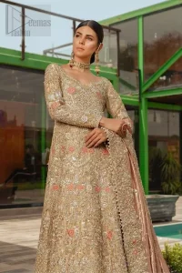 Nothing speaks of femininity and class louder than this outfits for bridesmaids. It is highlighted with golden and silver kora, dabka, tilla, sequins and pearls. The maxi is heavily ornamented with floral jaal done with zarozi work and floral motifs are decorated with peach and ivory thread embroidery. It comes with fawn lehenga adorned with scalloped embroidered bottom. Furthermore, lehenga is enhanced with peach frilled bottom. It is coordinated with peach dupatta which is sprinkled with sequins all over it. It is further furnished with four sided thick border.