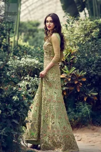 Nothing speaks of femininity and class louder than this mehndi outfits for bridesmaids. Steal the moment with this outfit with this shabby chic statement intensified with rich thread embroidery all over the front and bold patterns at daaman od the lehenga. Furthermore, it is enhanced with floral motifs all over decorated with multiple color thread embroidery. It is coordinated with parrot green blouse done with golden zardozi work and three quarter sleeves. Style it up with chiffon dupatta scattered with sequins all over.