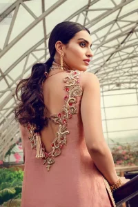 Delicately crafted and personifying chic elegance with an element of grandiose. You are all set to make a lasting impact with the divine royalty of this dress. The outfit is perfected with loaded dull golden, golden and antique work. The shirt is delicately hand crafted using the finest old age techniques and materials including kora, dabka, tilla, sequins and pearls. The back of the shirt is highlighted with cutwork embellishment. Furthermore it is also enhanced with thread embroidery. This outfit is comprises with peach raw silk bell bottom. Complete the look with peach organza dupatta decorated with sequins spray all over.