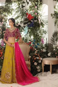 Adorn yourself with this breath-taking mehndi lehenga outfit. This beautiful mehndi dress comes with yellow lehenga with scattered beautiful embellished motifs and floral booties around a large central motif and it finished with frilled border. It is coordinated with a beautiful plum blouse adorned with zardozi work in the shades of golden and silver. Style it up with pink organza dupatta with sequins sprayed all over it along with gota finishing on all four sides.