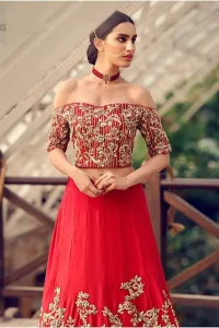 Captured in traditional silhouette, The bridal stands out due to its uniqueness and the perfect fusion of modern cut and traditional embroidery. This dress is beautifully decorated with heavy embroidery. It is highlighted with kora, dabka, tilla, sequins and pearls. Off shoulder blouse is enhanced with zardosi work all over. It comes with full embellished lehenga adorned with floral booties and vertical lines all over it. It is coordinated with net dupatta which is sprinkled with sequins all over it. It is further furnished with four sided embellished border.