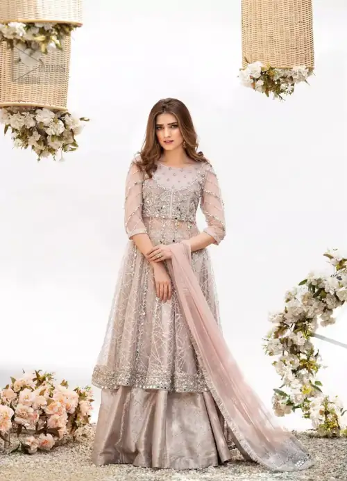 Embrace the season of festivities with this beautiful dress. Dazzle in this made to perfection, richly embroidered net outfit decorated