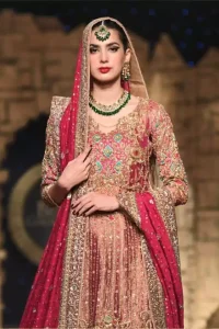 Nothing speaks of femininity and class louder than this outfit. This beautiful dress comes with burgundy A-Line frock with beautiful embellishment around the hem and vertically worked gold lines and it finished with a thick embellished border. The embroidery is done with golden, solver and antique shaded zardozi work. Furthermore it is also enhanced with multiple color thread embroidery in the floral motifs. Style it up with golden brocade sharara done with antique zardosi work at the bottom. This beautiful dress is comprises with burgundy dupatta sprinkled with sequins spray and four sided embroidered border.