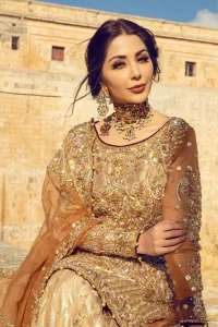 Dazzle in this made to perfection, richly embroidered ensemble accentuated with floral motifs and finished with scalp borders. Excellence of craftsmanship is evident with intricate detailing that features the use of kora, dabka, crystals, sequins and pearls. The Scalloped hemline is emphasided with dangling pearls. Balance the look with light golden lehenga adorned with golden, silver and antique shaded zardozi work. Dupatta comes with embellished alluring cut work floral border gives the perfect ending to this peplum.