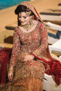 You are all set to make a lasting impact with the divine royalty of this dress. This ravishing ensemble is sure to make you look like glamorous royalty with immaculate work covering every inch of the shirt. It boasts a pretty scallop hemline and full sleeves with zardozi embellishment. Compliment the look with flared lehenga. The combination of rust with maroon is absolutely breathetaking. Elegance is personified when it gets paired up with an all-over sequins spray on dupatta dupatta with alternating scalloped borders detailing. This is an ensemble that deserves to be flaunted.