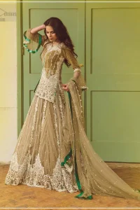 Let the crowd stare and make it worth their while when you walk wearing this outfit. Designed to flaunt your best features, the front open shirt carries intricate embellishment on the hemline and neckline. Complete the look with artfully coordinated lehenga which is ornamented with a bold and captivating design with a traditional intricate embroidery. Furthermore the lehenga and shirt is also emphasized with silver embroidered vertical lines. The fawn net dupatta with chann and scalloped finishing all around the edges makes the look complete. Upholding the idea of simple is beautiful, you would definitely want to wear this for your next occasion.