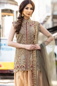 Our selection of wedding dresses offers simple evening glamour dresses. Add a taupe gray color to your wardrobe with our modern styled front open shirt enhanced with embellished geometric patterns. The neckline is beautifully designed with collar neck and scalloped hemline is emphasized with dangling pearls and multiple color embroidery. It is paired with taupe gray dupatta with one sided hand embellished border and sprinkled sequins all over. Compliment the look with fawn lehenga adorned with floral bunches. The combination of fawn and taupe gray is absolutely breathetaking.