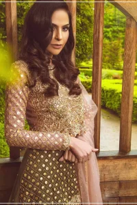 Nothing speaks of femininity and class louder than this mehndi outfits for bridesmaids. The motifs on the mehndi lehenga for a wedding are a true example of decorative and ornamental expression stylized in a contemporary way. The chic yet elegant mehndi green lehenga is decorated with zardozi embellished vertical lines, geometric patterns adorned with gotta work and floral bunches. Borders are even more enhanced with detailed motifs and finished with scallops. The blouse is fully decorated with floral embroidery all over with zardozi work in the shades of golden and antique. The look is completed with organza dupatta with embroidered lace borders and sequins spray all over.