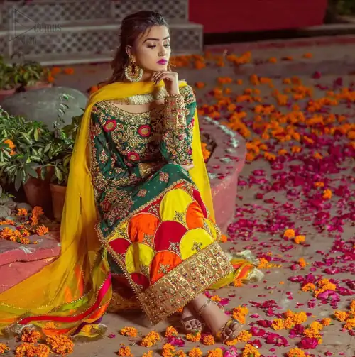 Beautifully elegant with a modern twist. This beautiful outfit comes with bottle green long shirt and colorful applique hemline, making