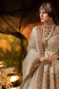 Delicately crafted and personifying chic elegance with an element of grandiose. This outfit is beautifully sculptured with geometric embroidery, adorned with heavy embellished bottom with golden and antique shaded kora, dabka, pearl and sequins work all over. Furthermore the outfit is emphasized with colorful thread work and mukesh embroidery. It is coordinated with ivory dupatta with sequins sprayed all over it along with zardozi work all around the edges to make the look complete.