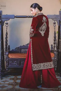 Steal the show with this endearing velvet outfit with intricate yet rich embroidery. The chic yet elegant front open shirt is decorated with embroidered patterns, embellished collar neckline and floral bunches. Hemline is even more enhanced with detailed zardozi work. The back of the shirt has a central large motif on the bodice while the zardozi work creates drama on both front and back panels. Beautifully paired up with maroon palazzo pants. Finish the look with maroon organza dupatta adorned with tiny floral motifs all over.