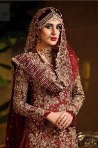 Captured in traditional silhouette. The bridal stands out due to its uniqueness and the perfect fusion of modern cut and traditional embroidery. This dress is beautifully highlighted with zardozi work in the shades of tan and silver. The hemline of the shirt is adorned with scalloped finishing and tassels on the sleeves. It comes with katan banarsi gharara with wide flare decorated with kora, dabka, tilla and pearls work. It is coordinated with organza dupatta which is sprinkled with sequins all over it. It is further furnished with four sided scalloped border.