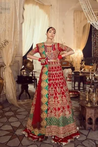 Classic, timeless and truly beautiful, our bridal dress is perfect for your unforgettable day. Our bride makes a statement in this stunningly floraison, perfect blend of glamour and tradition with outstanding craftsmanship and gorgeous detailing. The floor length maxi is delicately crafted with golden kora, dabka, tilla, sequins and pearls work. Furthermore it is adorned sea green applique with rich patterns and delicate details at the daaman. Crushed chiffon sharara are included to complete the look. This beautiful dupatta with rich embroidered motifs places artistically on the borders gives it a royal look.