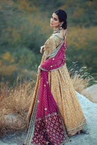 This exceptionally detailed anarkali frock is cut in a seductive fit and flare silhouette that’s sure to turn heads. The bodice with round neckline is adorned in richly beaded work with fabulous sparkle and zardozi work. Furthermore the panels of the shirt is vertically adorned with golden kora, dabka, tilla work and various flora motifs meticulously using on the ground. The frock is comprises with ferozi lehenga emphasized with criss cross patterns done with golden embellishment. Elegance is personified when it gets paired up with an embroidered dupatta with alternating motifs and sequins detailing.